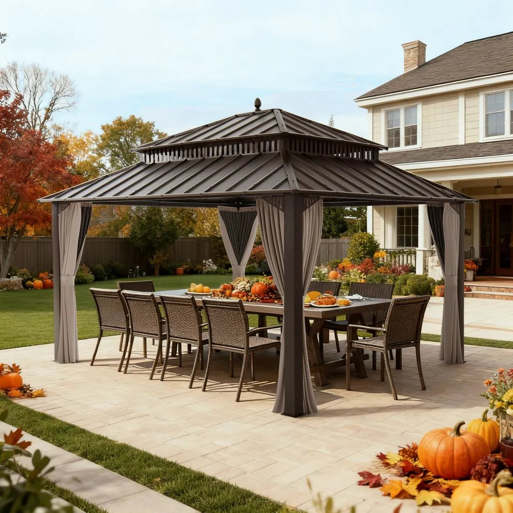 Outdoor gazebo with dining table and chairs on a patio, surrounded by autumn decorations.