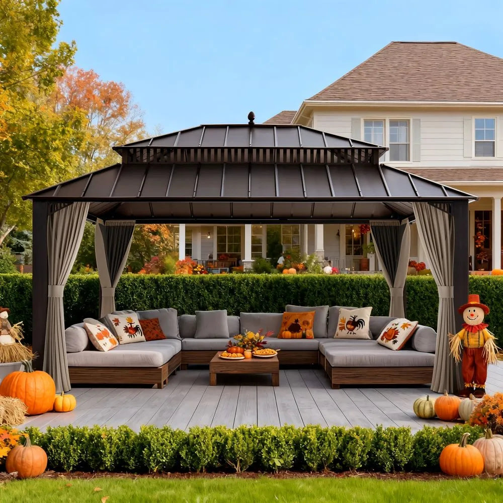 Outdoor patio with gazebo, sectional sofa, and Halloween decorations in front of a house.