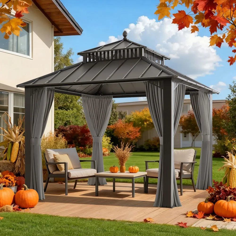 Patio gazebo with curtains, chairs, and pumpkins in a backyard setting.