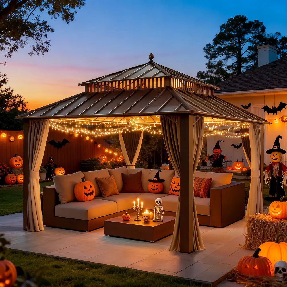 Outdoor gazebo decorated for Halloween with lights, pumpkins, and curtains.
