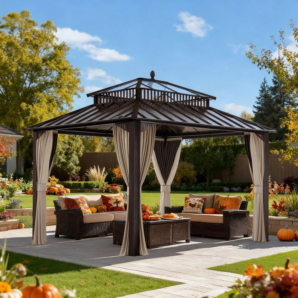 Outdoor gazebo with curtains, patio furniture, and pumpkins on a sunny day.