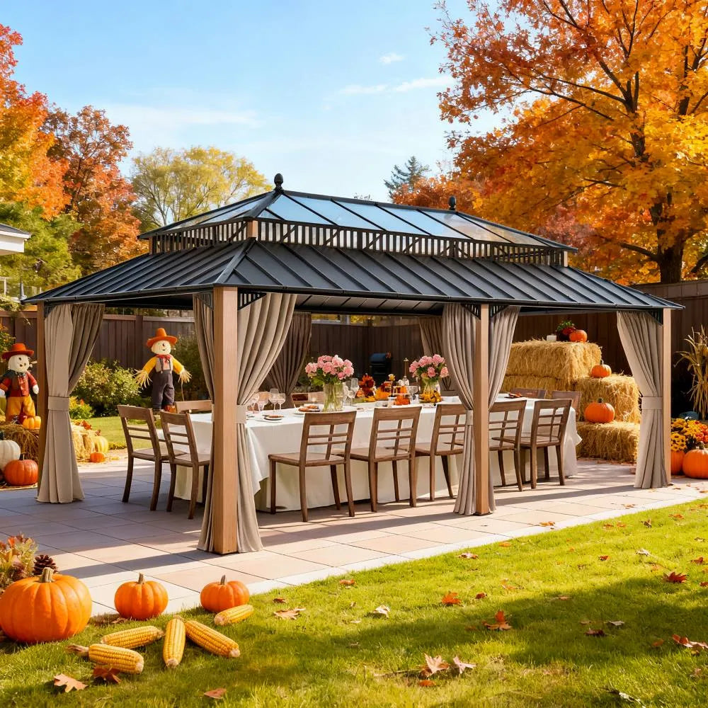 Outdoor gazebo with tables and chairs set up, surrounded by autumn decorations and trees with fall foliage.
