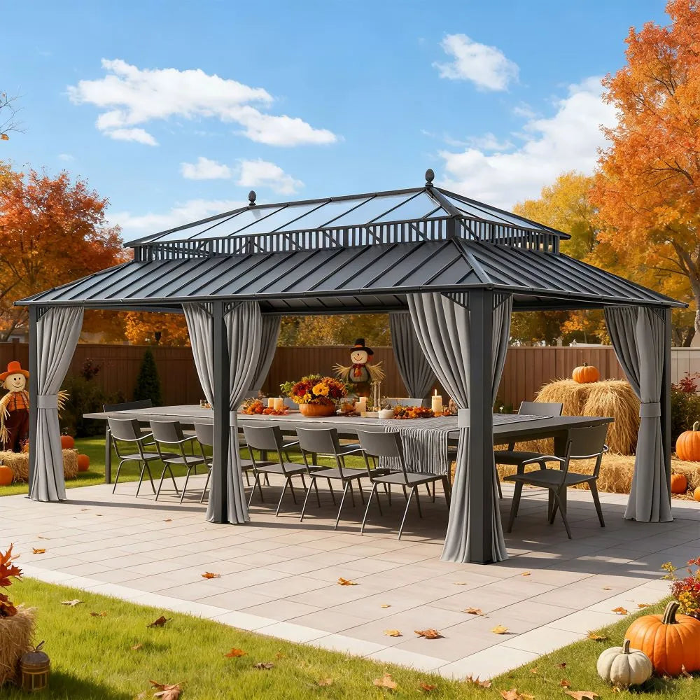 Outdoor gazebo with curtains, table, chairs, and autumn decorations on a patio.