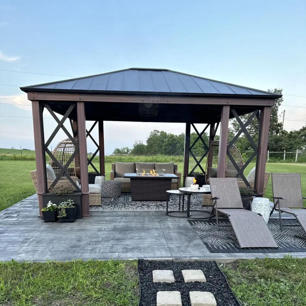 Outdoor patio with gazebo, furniture, and fire pit in a grassy area.