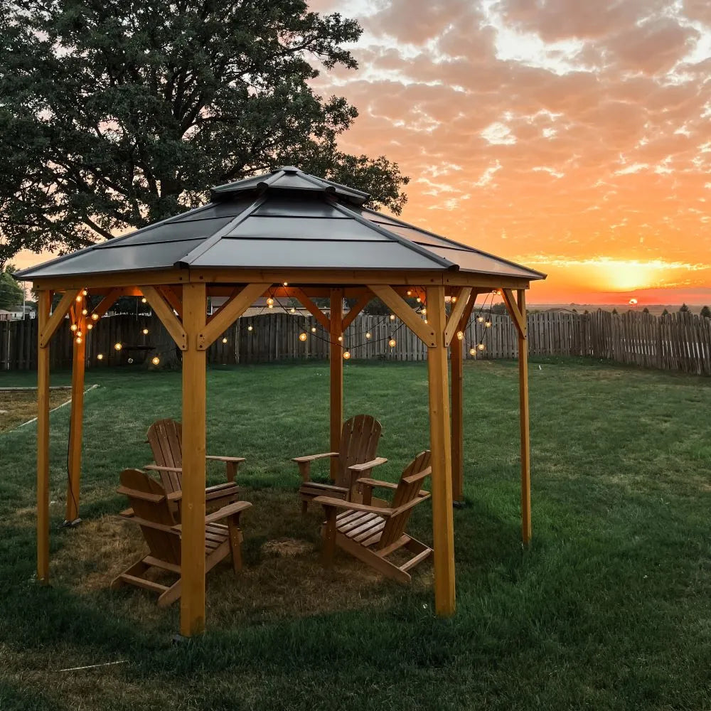 Wooden gazebo with Adirondack chairs under a sunset sky