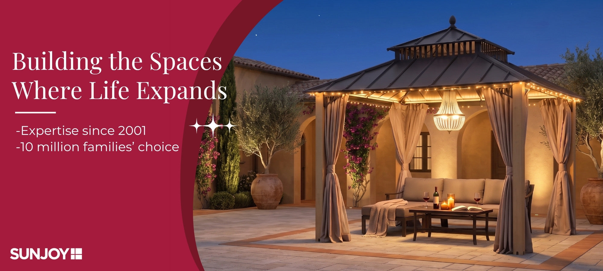 Outdoor patio scene at dusk featuring a large hardtop gazebo with draped curtains, warm string lighting, and a chandelier, set beside a stucco building. Large red graphic banner on the left contains marketing text and the SUNJOY logo.